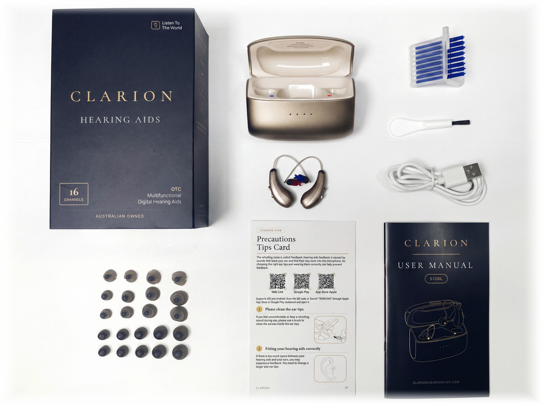 The complete Clarion Clarity S3 kit laid out on white: the retail box, the charging case, both hearing aids, twenty-two ear tips, eight wax guards, a cleaning brush, a USB-C cable and the user manual.